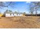View of the large backyard with its mature trees and partial fence surround at 3 Coral Dr, Goose Creek, SC 29445