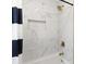 Luxurious bathroom with marble tile, a gold shower head, and built-in shelving at 3 Coral Dr, Goose Creek, SC 29445