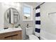 Bathroom featuring a stylish vanity, round mirror, tub, and designer shower curtain at 3 Coral Dr, Goose Creek, SC 29445