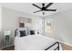 Comfortable bedroom featuring a black metal bed frame, modern ceiling fan, and a bright window at 3 Coral Dr, Goose Creek, SC 29445