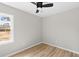 An empty bedroom featuring a ceiling fan, light gray walls, and new vinyl floor at 3 Coral Dr, Goose Creek, SC 29445