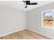 Vacant bedroom featuring new vinyl floors, a modern ceiling fan, and fresh gray paint at 3 Coral Dr, Goose Creek, SC 29445