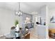 Bright dining room with a glass table, modern lighting, and contemporary gray cabinets at 3 Coral Dr, Goose Creek, SC 29445
