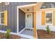 Welcoming front porch showcasing a stylish door, modern accents, and a glimpse of the interior at 3 Coral Dr, Goose Creek, SC 29445