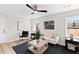 Bright living room offers neutral decor, modern ceiling fan, and lots of natural light at 3 Coral Dr, Goose Creek, SC 29445