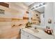 Bathroom featuring light wood paneling, white vanity, and decorative sunflower accents, creating a warm and inviting space at 313 Lapwing Ln, Mount Pleasant, SC 29464