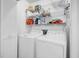 Laundry room featuring a washer and dryer, along with shelving for storage, providing convenience and organization at 313 Lapwing Ln, Mount Pleasant, SC 29464