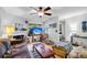 Comfortable living room with a fireplace, ceiling fan, and large windows that brings lots of natural light at 313 Lapwing Ln, Mount Pleasant, SC 29464