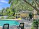Community swimming pool and recreation area featuring chairs and lake view at 313 Lapwing Ln, Mount Pleasant, SC 29464