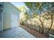 Backyard patio featuring a storage door, fence with a wooded view, and some greenery at 393 Flyway Rd, Goose Creek, SC 29445