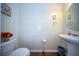 Half bathroom featuring hardwood floor, toilet, and wash basin at 393 Flyway Rd, Goose Creek, SC 29445
