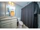 Cozy bathroom featuring a vanity with granite countertop and a shower with a modern gray shower curtain at 393 Flyway Rd, Goose Creek, SC 29445