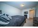 Bright bedroom includes carpet flooring, a large bed, and television at 393 Flyway Rd, Goose Creek, SC 29445