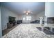 Kitchen counter with stainless steel faucet overlooking living room with plush seating at 393 Flyway Rd, Goose Creek, SC 29445