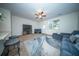 Cozy living room with plush blue seating, ceiling fan, and large windows for natural light at 393 Flyway Rd, Goose Creek, SC 29445
