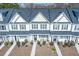 Charming townhomes featuring a symmetrical design, inviting entrances, and well-kept lawns at 393 Flyway Rd, Goose Creek, SC 29445