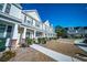Street view of townhomes featuring tidy landscaping, welcoming entrances, and classic design at 393 Flyway Rd, Goose Creek, SC 29445