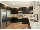 Modern kitchen with dark cabinetry, quartz countertops, and stainless steel appliances at 5135 Park Creek Avenue, North Charleston, SC 29418