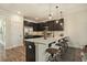 Modern kitchen with dark cabinetry, quartz countertops, and stainless steel appliances at 5135 Park Creek Avenue, North Charleston, SC 29418
