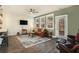 Living area with hardwood floors, leather sofa, and access to backyard at 5135 Park Creek Avenue, North Charleston, SC 29418