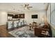 Spacious living room with hardwood floors, a leather couch, and a ceiling fan at 5135 Park Creek Avenue, North Charleston, SC 29418