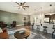 Open concept living room with hardwood floors, leather seating, and kitchen island at 5135 Park Creek Avenue, North Charleston, SC 29418