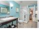 Bright bathroom featuring a glass shower, vanity with granite countertop, and blue accent wall at 5804 Palmetto Dr # A-401/403, Isle of Palms, SC 29451