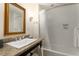 Neutral bathroom with a vanity featuring a granite countertop, a large mirror, and a shower-tub combo at 5804 Palmetto Dr # A-401/403, Isle of Palms, SC 29451