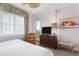 Comfortable bedroom featuring a cozy seating area, dresser, and bright natural lighting at 5804 Palmetto Dr # A-401/403, Isle of Palms, SC 29451