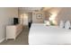 Neutral-toned bedroom featuring two double beds, and a dresser with a TV at 5804 Palmetto Dr # A-401/403, Isle of Palms, SC 29451
