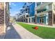 Bright blue condo building with outdoor green space, walkways, and unique architectural details at 5804 Palmetto Dr # A-401/403, Isle of Palms, SC 29451