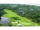 Aerial view of lush golf course, water, and mature trees at 619 Magnolia Walk Villas, Edisto Island, SC 29438