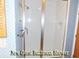 Bright bathroom featuring a walk-in shower with glass doors and modern fixtures at 619 Magnolia Walk Villas, Edisto Island, SC 29438