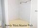 Elegant Primary bathroom featuring a corner tub and shower with marble tile at 619 Magnolia Walk Villas, Edisto Island, SC 29438