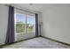 Bright bedroom featuring hardwood floors, large windows with a view, and stylish curtains at 637 N Laurel St # 75, Summerville, SC 29483