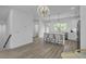 Open-concept kitchen with a large island, modern lighting, and stainless steel appliances at 637 N Laurel St # 75, Summerville, SC 29483