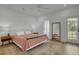 A bedroom with a ceiling fan, a wooden floor, a door to a balcony, and an ornate rug at 637 N Laurel St # 75, Summerville, SC 29483