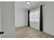 Bright bedroom featuring light wood floors, modern black hardware, and a large window with sheer curtains at 637 N Laurel St # 75, Summerville, SC 29483