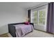 This bedroom features a stylish daybed, curtains, and a large window offering an inviting view at 637 N Laurel St # 75, Summerville, SC 29483
