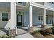 Inviting apartment entrance with elegant columns, brick accents, and stylish black front door at 637 N Laurel St # 75, Summerville, SC 29483