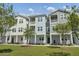 Attractive apartment units with well-manicured front lawns, sidewalk access, and welcoming entrances at 637 N Laurel St # 75, Summerville, SC 29483