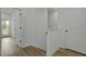 Hallway with light wood flooring and white walls and doors with black hardware at 637 N Laurel St # 75, Summerville, SC 29483