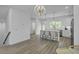Bright, open kitchen featuring hardwood floors, white countertops, and bar seating at 637 N Laurel St # 75, Summerville, SC 29483