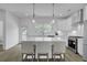 A bright kitchen featuring white cabinets, pendant lights, stainless appliances, and modern finishes at 637 N Laurel St # 75, Summerville, SC 29483