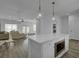 Modern kitchen island featuring hardwood floors, white countertops, and stainless steel microwave at 637 N Laurel St # 75, Summerville, SC 29483