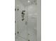 An elegant shower with a frameless glass door, white tile walls, and a rainfall shower head at 637 N Laurel St # 75, Summerville, SC 29483