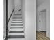 Modern staircase features a gray and white design with a sleek handrail and plenty of natural light at 637 N Laurel St # 75, Summerville, SC 29483