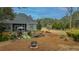 Large backyard with fire pit, hot tub, and lush landscaping at 788 Awendaw Lakes Blvd, Awendaw, SC 29429