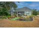 Home's exterior showcasing a large backyard with hot tub and patio at 788 Awendaw Lakes Blvd, Awendaw, SC 29429