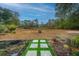 Landscaped backyard with fire pit and open space at 788 Awendaw Lakes Blvd, Awendaw, SC 29429